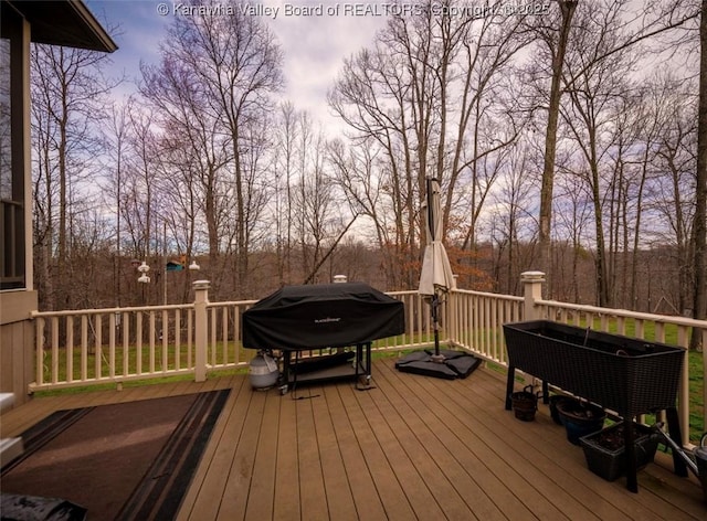 356 Latigo Pt, Milton, WV 25541 - deck featuring area for grilling and view of wooded area