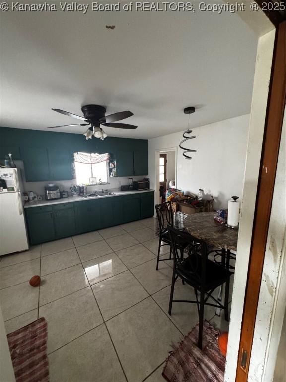 dining room with a ceiling fan and light tile patterned floors