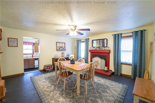 dining area with a textured ceiling, baseboards, and ceiling fan