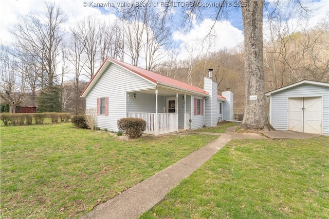view of front of home with a chimney, an outbuilding, a storage unit, a front lawn, and covered porch