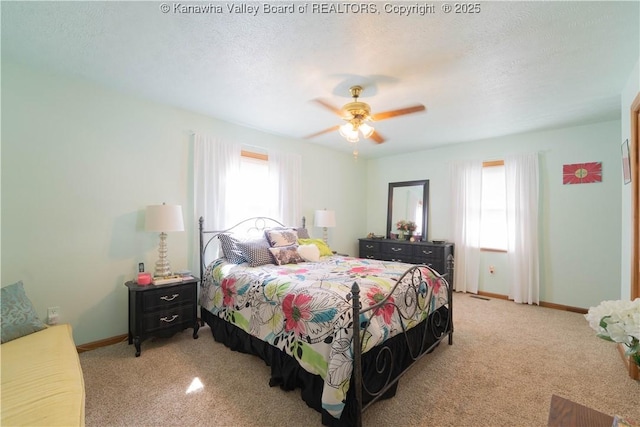 bedroom with multiple windows, light colored carpet, and baseboards