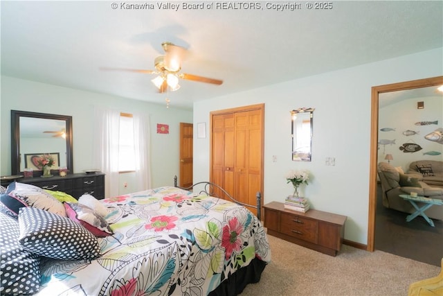 bedroom featuring light colored carpet, a closet, baseboards, and a ceiling fan