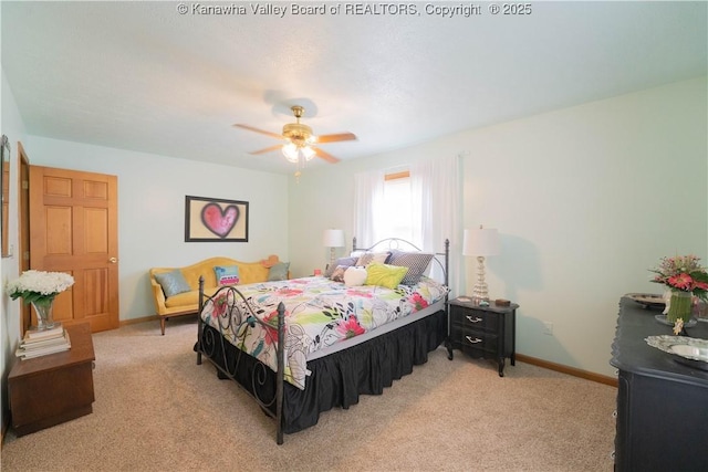 bedroom with light colored carpet, ceiling fan, and baseboards