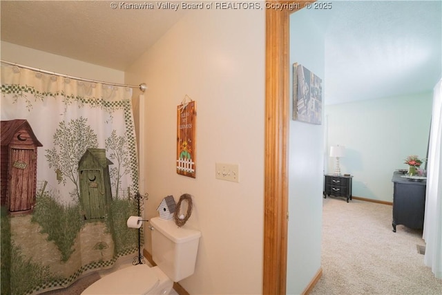 bathroom featuring baseboards and toilet