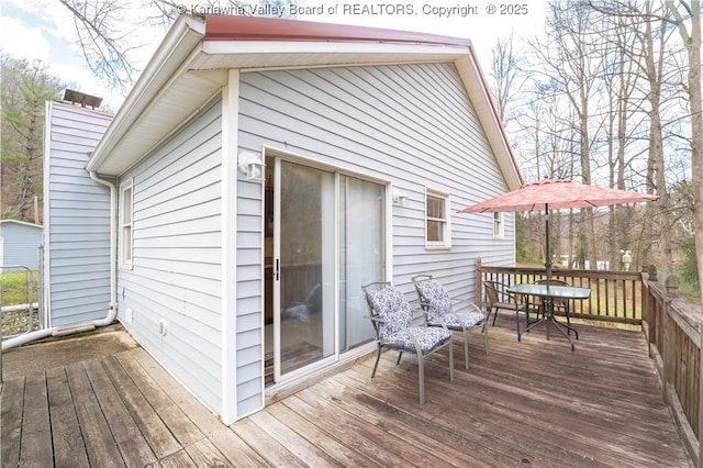 wooden deck with outdoor dining space