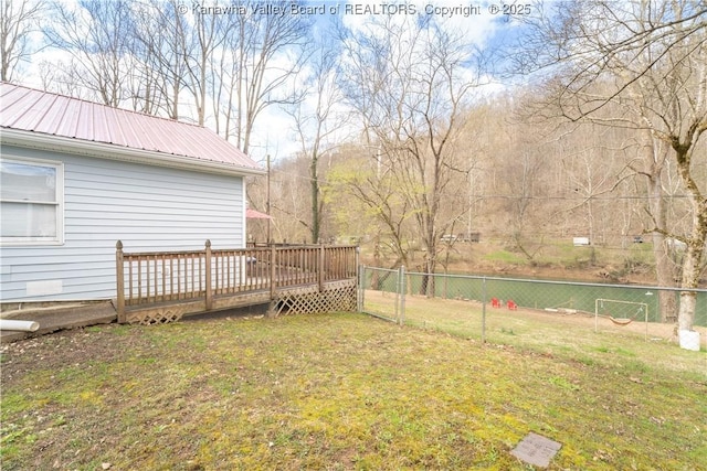 view of yard with a deck and fence