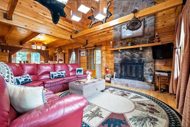 510 Shamrock Dr, Union, WV 26833 - living area featuring wood walls, wooden ceiling, a towering ceiling, a stone fireplace, and wood finished floors