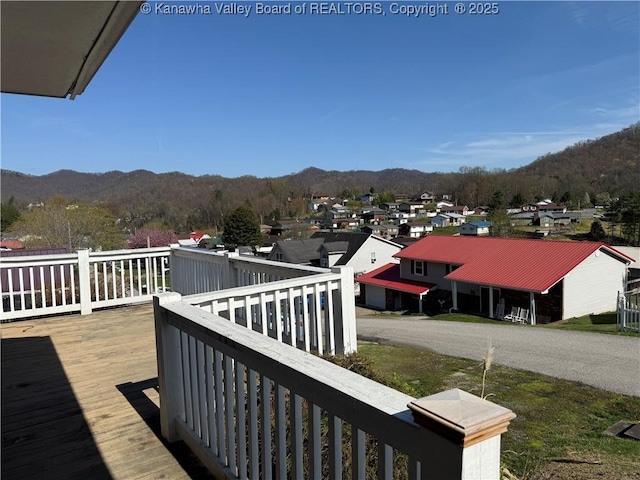 exterior space featuring a residential view and a deck with mountain view