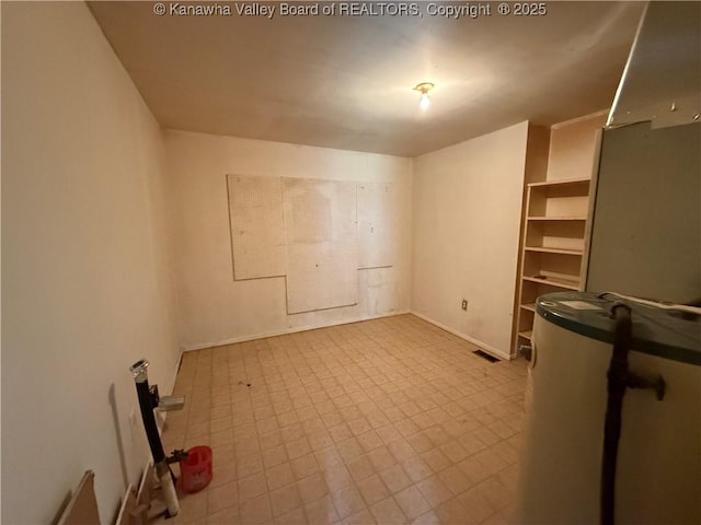 spare room featuring tile patterned floors and visible vents