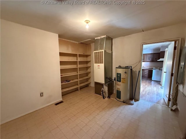 below grade area with water heater, tile patterned floors, and visible vents