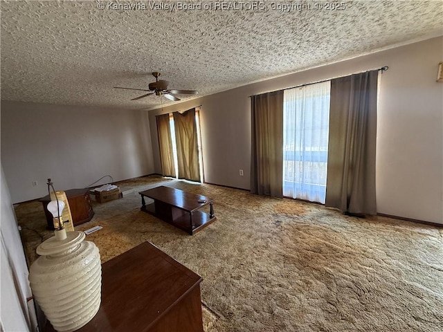 living room with a textured ceiling, ceiling fan, and carpet