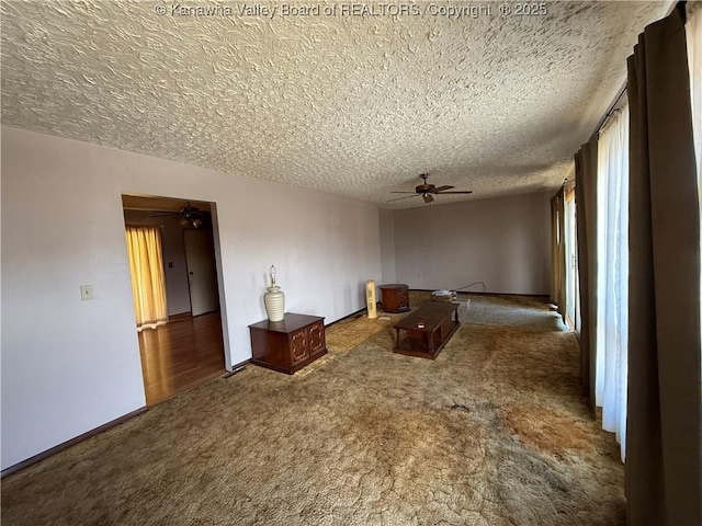 interior space featuring baseboards, a textured ceiling, and a ceiling fan