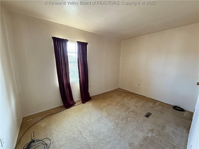 carpeted spare room with visible vents