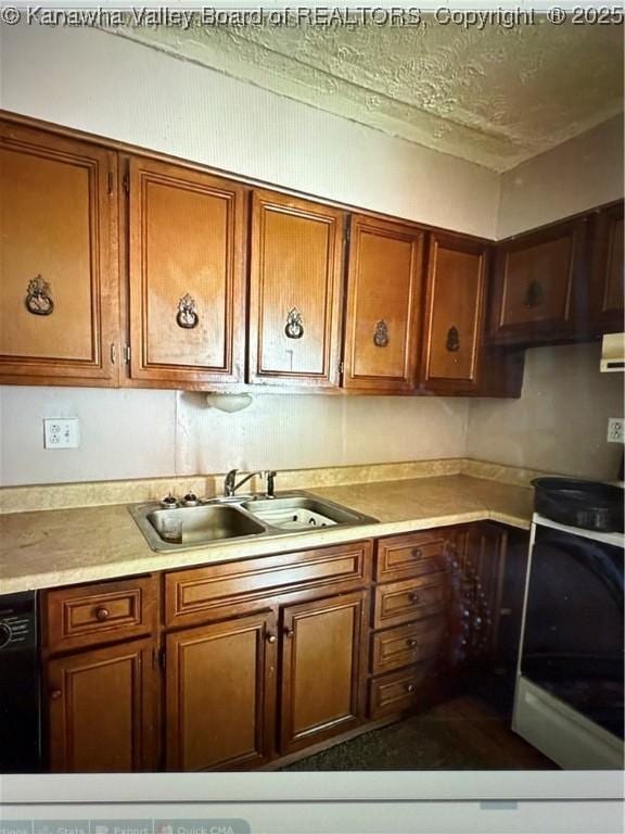 kitchen with black dishwasher, light countertops, a sink, and brown cabinetry