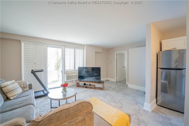 living area featuring marble finish floor and baseboards