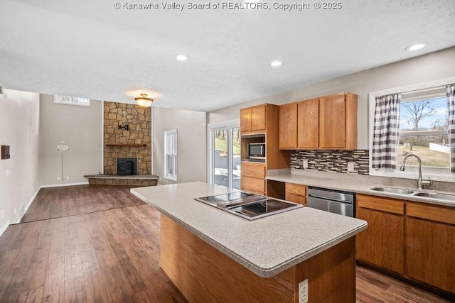 25 Lilly Hls, South Charleston, WV 25309 - kitchen with a center island, dark wood-style floors, a sink, a fireplace, and appliances with stainless steel finishes