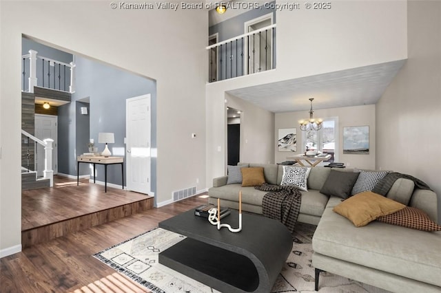 25 Lilly Hls, South Charleston, WV 25309 - living area featuring wood finished floors, visible vents, baseboards, a chandelier, and stairs