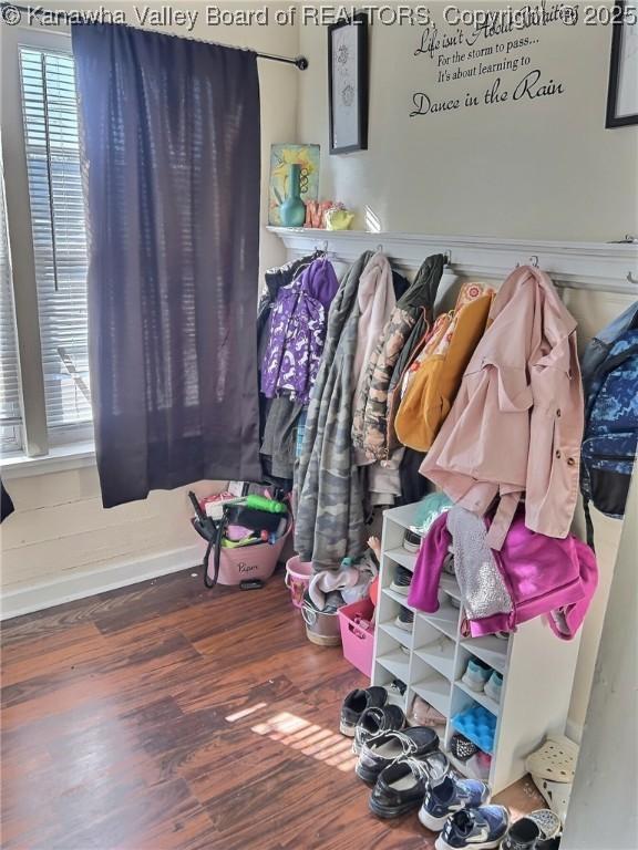 interior space featuring baseboards and wood finished floors