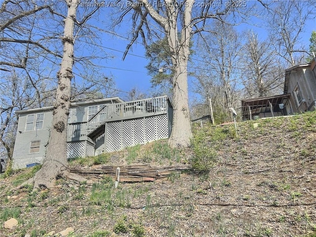 exterior space featuring a sunroom, stairs, and a deck