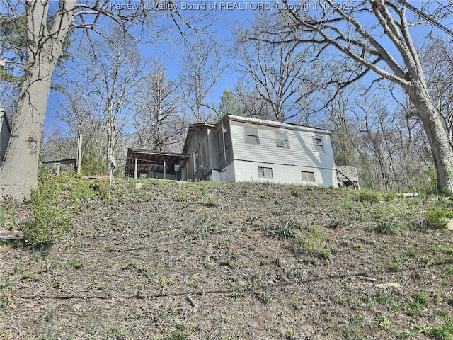 view of home's exterior with a sunroom
