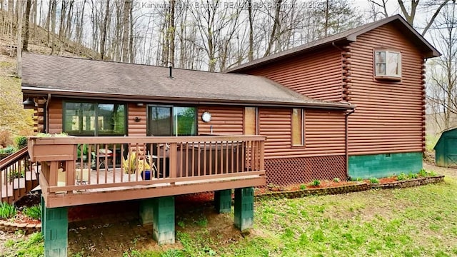 back of house with a wooden deck, a shingled roof, crawl space, and log siding