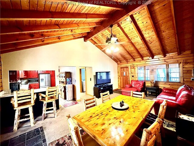 dining room with carpet floors, beamed ceiling, ceiling fan, high vaulted ceiling, and wood ceiling
