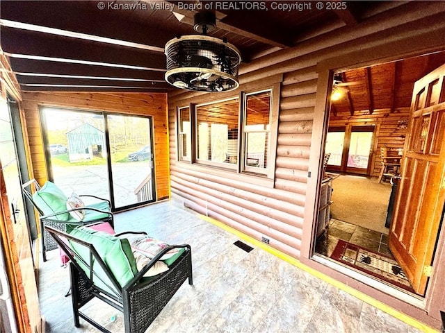 sunroom featuring beamed ceiling