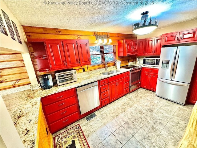 kitchen with a sink, appliances with stainless steel finishes, a toaster, and a textured ceiling