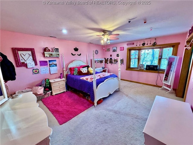carpeted bedroom with visible vents, baseboards, and a ceiling fan