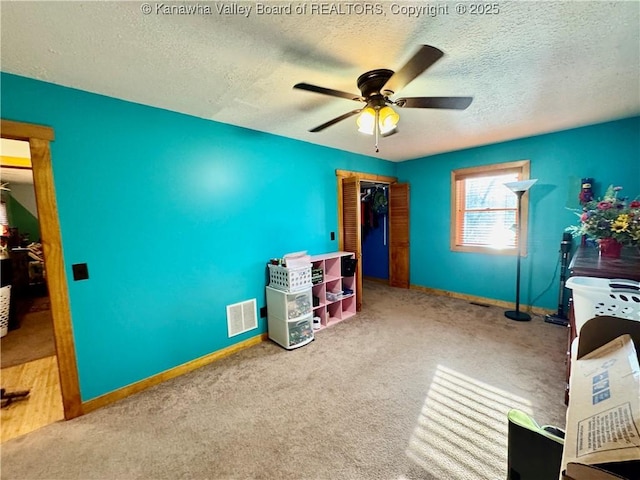 unfurnished bedroom featuring carpet, visible vents, baseboards, and a textured ceiling