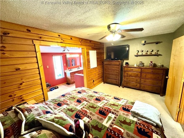 bedroom with wood walls, light carpet, and a textured ceiling