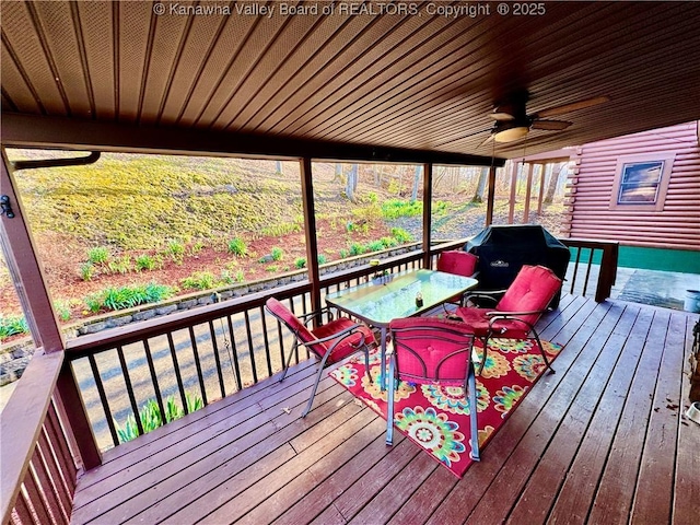 wooden terrace with outdoor dining area, a grill, and ceiling fan