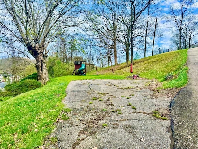 view of home's community with a lawn and playground community