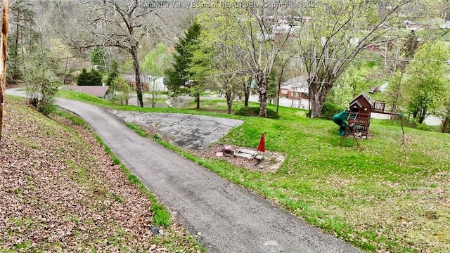 view of property's community featuring a yard and a playground