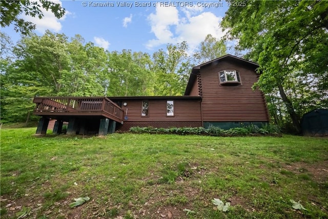 23 Mindia Ln, Alum Creek, WV 25003 - back of property featuring a deck, a lawn, log siding, and a storage shed