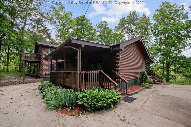 23 Mindia Ln, Alum Creek, WV 25003 - cabin with log siding, stairway, and a porch