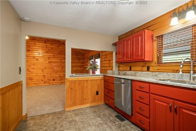 23 Mindia Ln, Alum Creek, WV 25003 - kitchen featuring dishwasher, a sink, wooden walls, plenty of natural light, and wainscoting