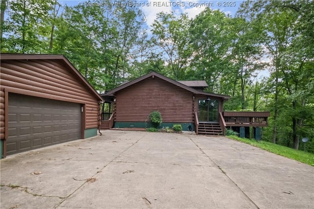 23 Mindia Ln, Alum Creek, WV 25003 - log-style house featuring log exterior, a deck, driveway, and a garage