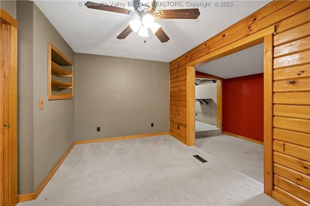 23 Mindia Ln, Alum Creek, WV 25003 - carpeted spare room featuring baseboards, ceiling fan, and wooden walls