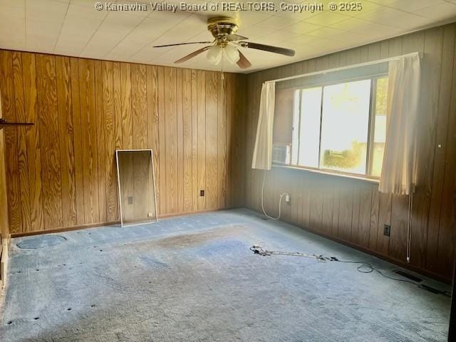 161 Kanawha Ave, Smithers, WV 25186 - carpeted empty room featuring a ceiling fan and wood walls