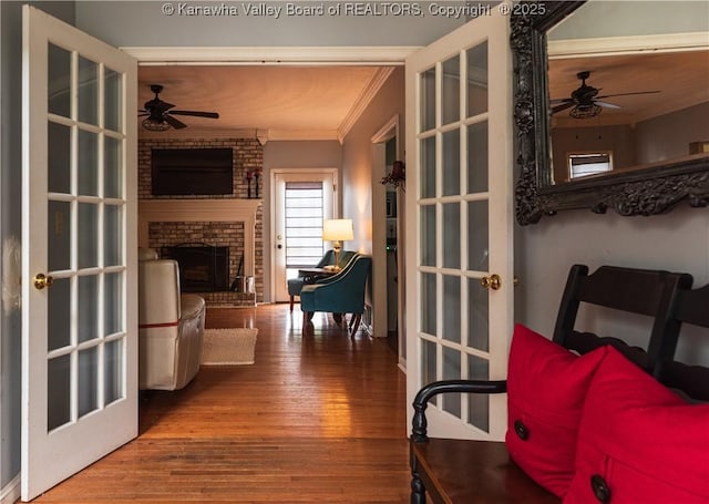 120 Rosewood Dr, Hurricane, WV 25526 - interior space featuring ornamental molding, a ceiling fan, wood finished floors, and a brick fireplace
