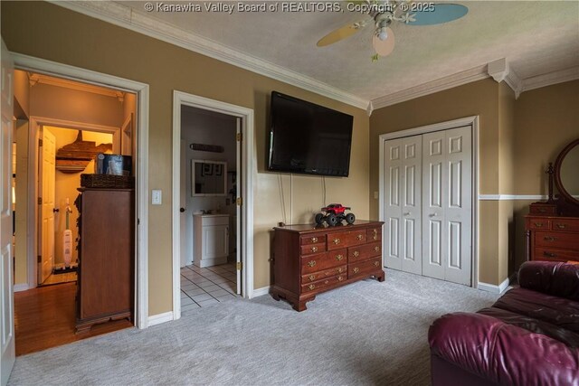 120 Rosewood Dr, Hurricane, WV 25526 - carpeted bedroom with a closet, crown molding, baseboards, ensuite bath, and ceiling fan