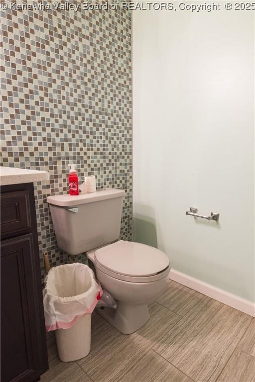 120 Rosewood Dr, Hurricane, WV 25526 - half bath featuring toilet, baseboards, vanity, and tile walls