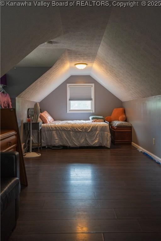 120 Rosewood Dr, Hurricane, WV 25526 - bedroom featuring hardwood / wood-style flooring, vaulted ceiling, and a textured ceiling