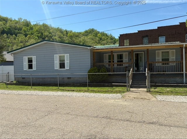view of front of home featuring covered porch and a fenced front yard