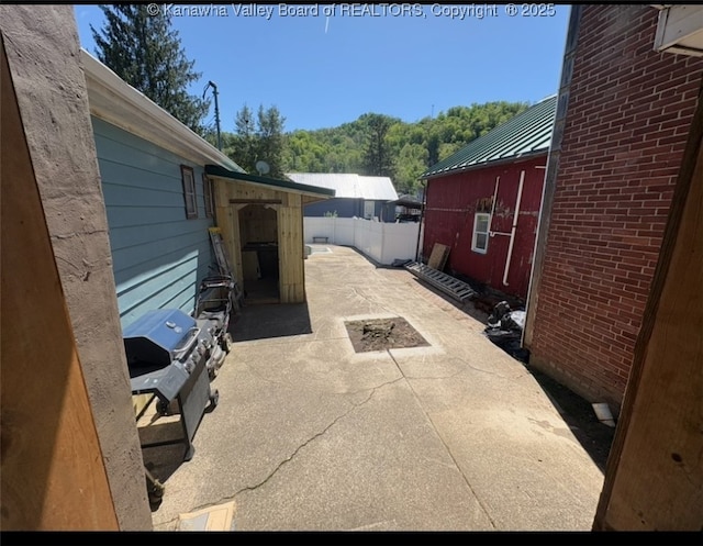 view of patio with fence and area for grilling