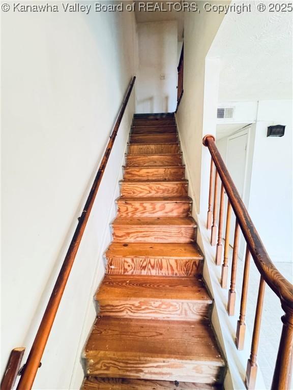 staircase featuring visible vents