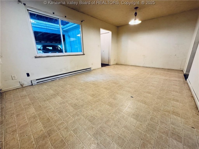 unfurnished room featuring tile patterned floors and baseboard heating