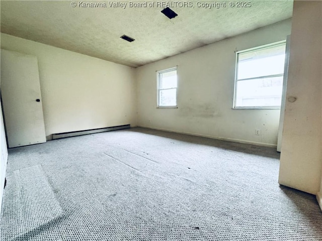 unfurnished room with a textured ceiling, carpet, and baseboard heating