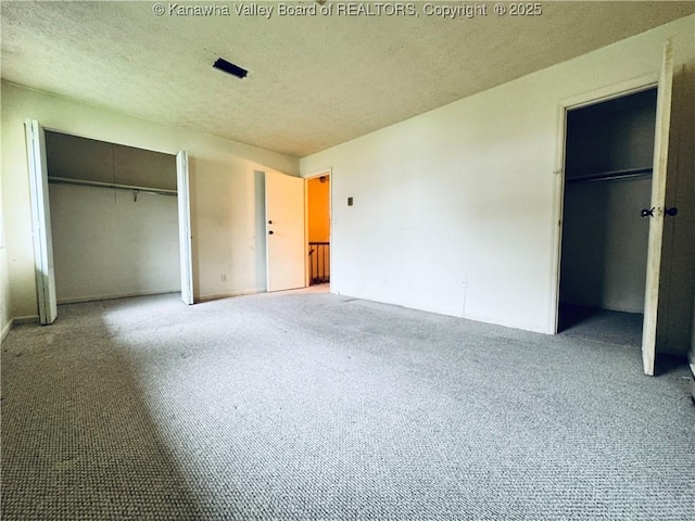 unfurnished bedroom with carpet flooring, a closet, and a textured ceiling